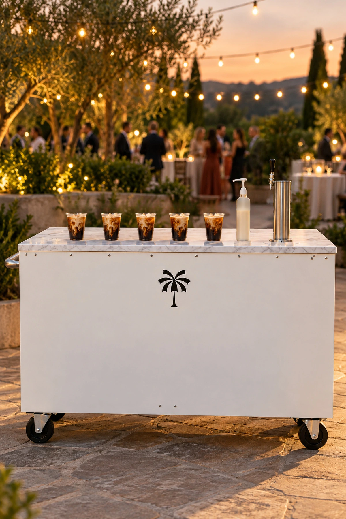 The Mabu iced coffee cart set with cold brews at an evening event under string lights
